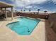 Beautiful in-ground pool with a lounge area, spa, and privacy wall at 10071 Lemon Valley Ave, Las Vegas, NV 89147
