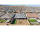 Back aerial view showcasing gray roof, backyard, and views of the surrounding community at 10095 Ferton Lake Ave, Las Vegas, NV 89178