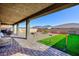 Backyard patio features pavers, artificial turf, desert landscaping, BBQ, and a firepit at 10095 Ferton Lake Ave, Las Vegas, NV 89178