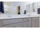 Bathroom featuring a double vanity with white countertops and modern sinks at 10095 Ferton Lake Ave, Las Vegas, NV 89178