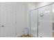 Bathroom with a glass-enclosed shower and white door, providing a sleek and modern design at 10095 Ferton Lake Ave, Las Vegas, NV 89178