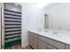 Modern bathroom with double vanity, white countertops, and walk-in shower access at 10095 Ferton Lake Ave, Las Vegas, NV 89178