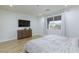 Bright bedroom with wood-look floors, large window, and dresser at 10095 Ferton Lake Ave, Las Vegas, NV 89178