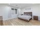 Bright bedroom with wood-look floors, large window, and rustic furniture at 10095 Ferton Lake Ave, Las Vegas, NV 89178