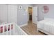 Bright bedroom features wood-look floors, closet, and a charming round mirror at 10095 Ferton Lake Ave, Las Vegas, NV 89178