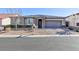 Charming single-story home featuring stone accents, a two-car garage, and meticulously landscaped front yard at 10095 Ferton Lake Ave, Las Vegas, NV 89178
