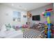Spacious playroom with toys, playhouses, and a comfortable white sofa for relaxation at 10095 Ferton Lake Ave, Las Vegas, NV 89178