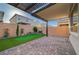 Beautiful backyard featuring a putting green, lush landscaping, and a covered patio for outdoor enjoyment at 10251 Tiger Milkweed St, Las Vegas, NV 89141