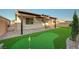 Backyard featuring a putting green, covered patio, and ample space for outdoor enjoyment at 10251 Tiger Milkweed St, Las Vegas, NV 89141