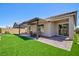 Wide view of patio area, putting green and artificial grass yard at 10251 Tiger Milkweed St, Las Vegas, NV 89141