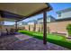 Backyard featuring a covered patio, putting green, and manicured landscaping perfect for outdoor living at 10251 Tiger Milkweed St, Las Vegas, NV 89141