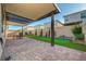 Spacious backyard with covered patio, putting green, and well-maintained landscaping, ideal for leisure and recreation at 10251 Tiger Milkweed St, Las Vegas, NV 89141