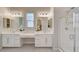 Bright bathroom features dual sinks, white cabinetry and a glass enclosed shower at 10251 Tiger Milkweed St, Las Vegas, NV 89141