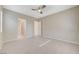 Spacious bedroom featuring tile flooring, ceiling fan, and neutral wall color at 10251 Tiger Milkweed St, Las Vegas, NV 89141