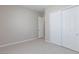 Bright bedroom featuring a closet with sliding doors, neutral walls, and tile flooring creating a serene space at 10251 Tiger Milkweed St, Las Vegas, NV 89141