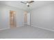 Bright, empty bedroom with ample room for a bed, ceiling fan, and an attached bathroom at 10251 Tiger Milkweed St, Las Vegas, NV 89141