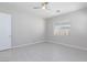 Bright bedroom features a ceiling fan, tile floors, a window, and a doorway at 10251 Tiger Milkweed St, Las Vegas, NV 89141