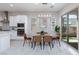 A modern dining area with a view to the outdoor patio, stainless steel appliances, and recessed lighting at 10251 Tiger Milkweed St, Las Vegas, NV 89141