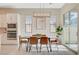 Beautiful dining room with modern light fixture, adjacent to the kitchen at 10251 Tiger Milkweed St, Las Vegas, NV 89141