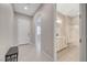 Inviting entryway boasts neutral tones, ceramic tile floors, and a convenient bench, leading to a bathroom with dual vanity sinks at 10251 Tiger Milkweed St, Las Vegas, NV 89141