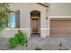 Attractive home exterior showcasing a lovely entryway, tasteful landscaping, and a two-car garage at 10251 Tiger Milkweed St, Las Vegas, NV 89141