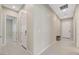 Bright hallway featuring ceramic tile floors and neutral paint, connecting various rooms within the home at 10251 Tiger Milkweed St, Las Vegas, NV 89141