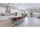 Bright kitchen features a large island with counter seating, stainless steel appliances and neutral color palette at 10251 Tiger Milkweed St, Las Vegas, NV 89141