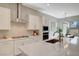 Stylish kitchen with sleek countertops, stainless steel range hood, and contemporary backsplash design at 10251 Tiger Milkweed St, Las Vegas, NV 89141