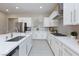 Bright kitchen with white cabinets, gray backsplash, stainless appliances, and a kitchen island at 10251 Tiger Milkweed St, Las Vegas, NV 89141