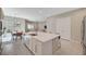 Open concept kitchen with a large island, stainless steel appliances, and seamless flow into the dining and living areas at 10251 Tiger Milkweed St, Las Vegas, NV 89141