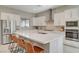 Spacious kitchen featuring stainless steel appliances, large island with seating, and white cabinetry at 10251 Tiger Milkweed St, Las Vegas, NV 89141