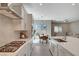 Bright, open kitchen features modern appliances, white cabinets, and a view into the dining and living areas at 10251 Tiger Milkweed St, Las Vegas, NV 89141