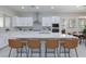 Modern kitchen featuring white cabinets, quartz countertops, and stainless steel appliances at 10251 Tiger Milkweed St, Las Vegas, NV 89141