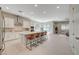 Open-concept kitchen with modern appliances, island seating, and dining room access at 10251 Tiger Milkweed St, Las Vegas, NV 89141