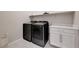 Modern laundry room equipped with sleek washer and dryer, ample counter space, and storage cabinets at 10251 Tiger Milkweed St, Las Vegas, NV 89141