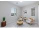 Cozy living room with abundant natural light, modern decor, and stylish furniture perfect for relaxation at 10251 Tiger Milkweed St, Las Vegas, NV 89141