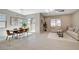 Open-concept living space combining the living room, dining area, and kitchen with ample natural light at 10251 Tiger Milkweed St, Las Vegas, NV 89141