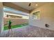 Cozy covered patio with brick pavers, artificial grass accents, and privacy wall, perfect for outdoor relaxation at 10251 Tiger Milkweed St, Las Vegas, NV 89141