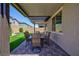 Covered patio with brick pavers, outdoor dining set, and backyard putting green at 10251 Tiger Milkweed St, Las Vegas, NV 89141