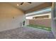 Charming covered patio featuring brick pavers, low-maintenance artificial grass, and a peaceful backyard view at 10251 Tiger Milkweed St, Las Vegas, NV 89141