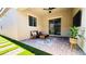 Charming covered patio with outdoor seating, brick pavers, and manicured greenery for serene outdoor living at 10251 Tiger Milkweed St, Las Vegas, NV 89141