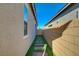 Low-maintenance side yard with pavers and artificial turf, offering a clean and functional outdoor space at 10251 Tiger Milkweed St, Las Vegas, NV 89141