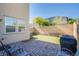 Private backyard with paved patio, artificial grass, and a seating area perfect for relaxing outdoors at 104 Pollentia Ave, North Las Vegas, NV 89084