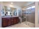 Modern bathroom with dual sinks, a spacious walk-in shower, and contemporary fixtures at 104 Pollentia Ave, North Las Vegas, NV 89084