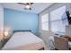 Bright bedroom with a tranquil ambiance, complemented by a study area and ample natural light at 104 Pollentia Ave, North Las Vegas, NV 89084