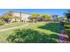 Well-maintained community park with lush green grass, a walkway, and a covered picnic area at 104 Pollentia Ave, North Las Vegas, NV 89084