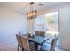 Bright dining area with access to the backyard, featuring a modern light fixture and comfortable seating at 104 Pollentia Ave, North Las Vegas, NV 89084