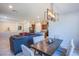 Open-concept dining area with modern light fixture, seamlessly flowing into the living room and kitchen at 104 Pollentia Ave, North Las Vegas, NV 89084