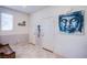 The entryway has tile floors, with a bench and a blue piece of artwork at 104 Pollentia Ave, North Las Vegas, NV 89084