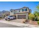 Charming two-story home featuring a two-car garage, a well-maintained yard, and a brick driveway at 104 Pollentia Ave, North Las Vegas, NV 89084